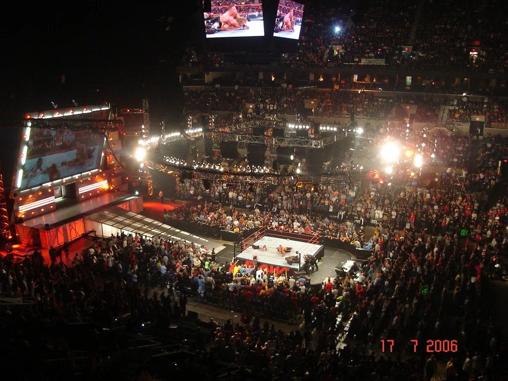 A WWE Raw arena with the ring, stage and television production lighting